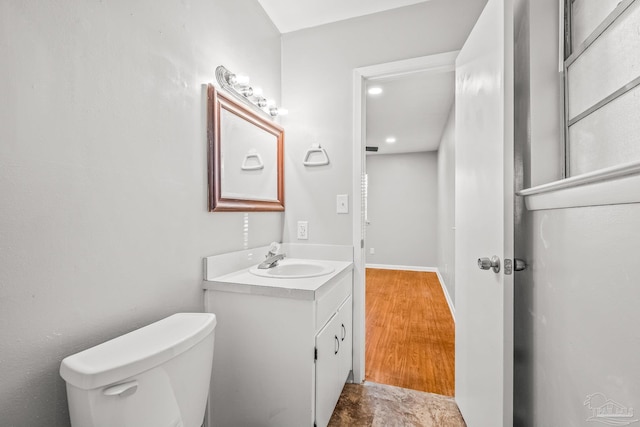 bathroom featuring hardwood / wood-style flooring, vanity, and toilet