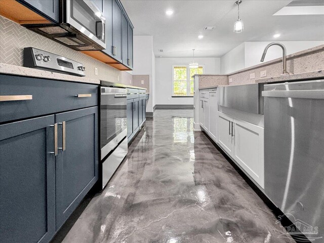 kitchen featuring hanging light fixtures, white cabinetry, and backsplash