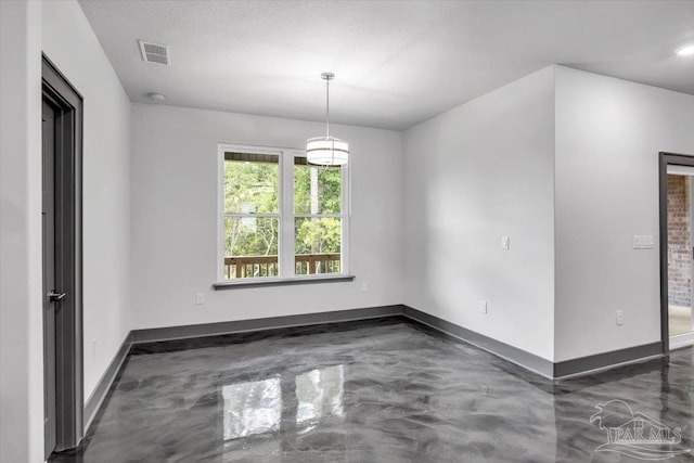 spare room featuring a textured ceiling