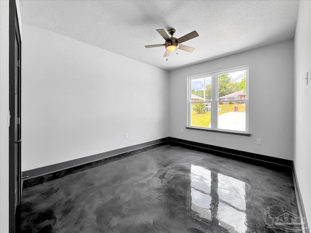 empty room featuring ceiling fan and a textured ceiling