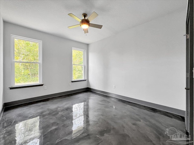 unfurnished room featuring ceiling fan and a textured ceiling