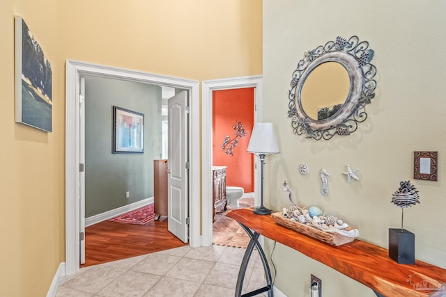 hall featuring light tile patterned floors