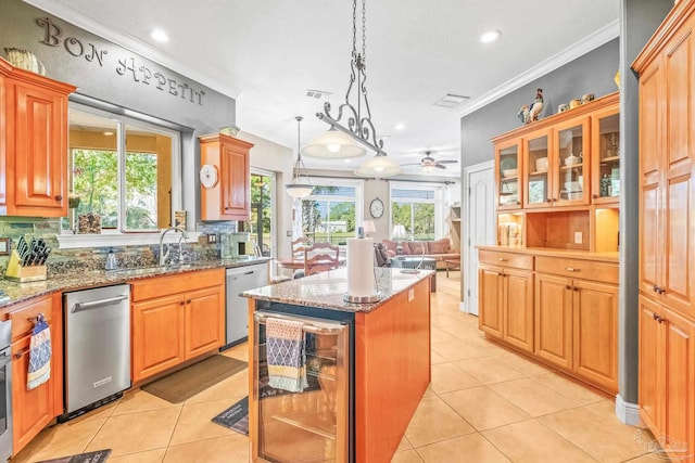 kitchen featuring dishwasher, a wealth of natural light, a kitchen island, and beverage cooler