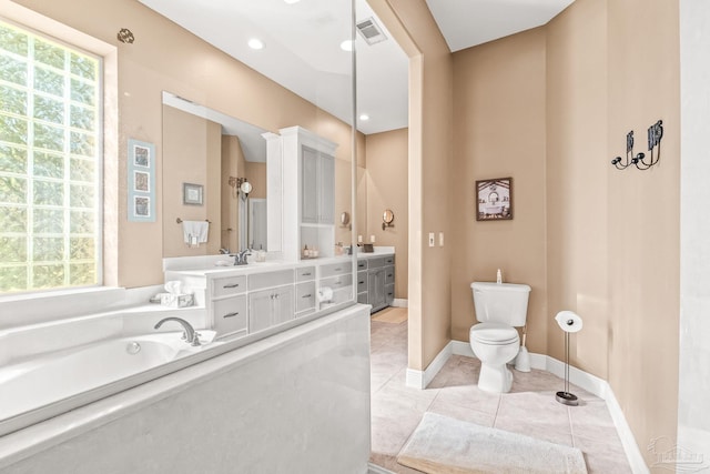 bathroom with vanity, toilet, a bath, and tile patterned flooring