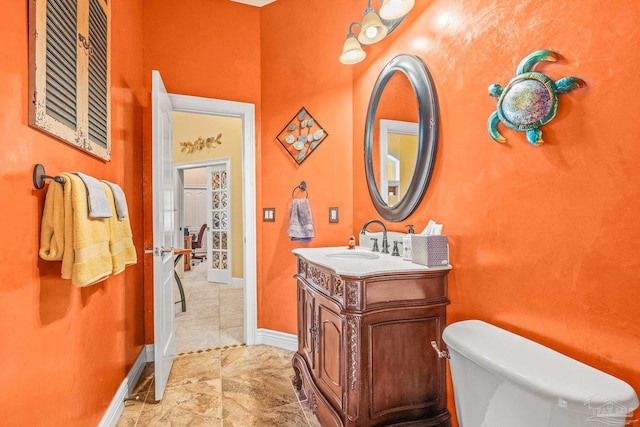 bathroom featuring toilet, vanity, and tile patterned floors