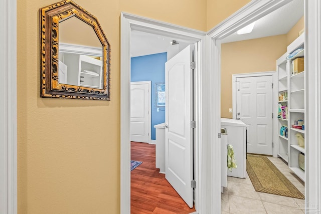 corridor featuring light hardwood / wood-style flooring and washer / clothes dryer