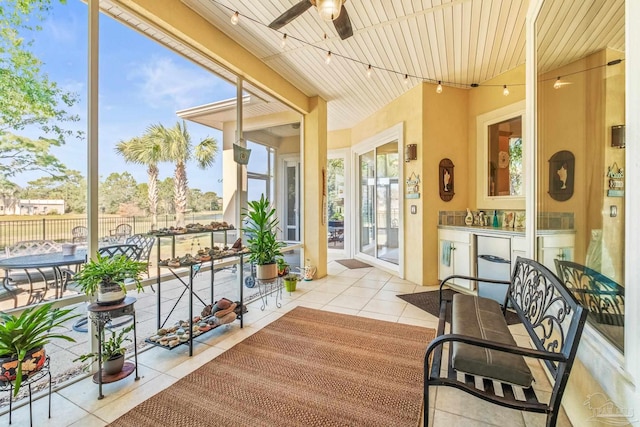 sunroom / solarium with wooden ceiling and ceiling fan