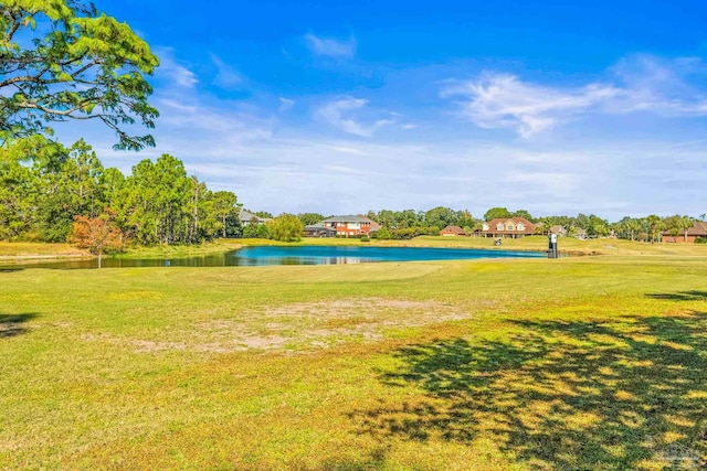 surrounding community with a yard and a water view