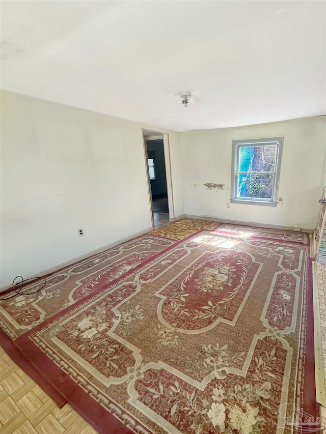 spare room featuring parquet flooring