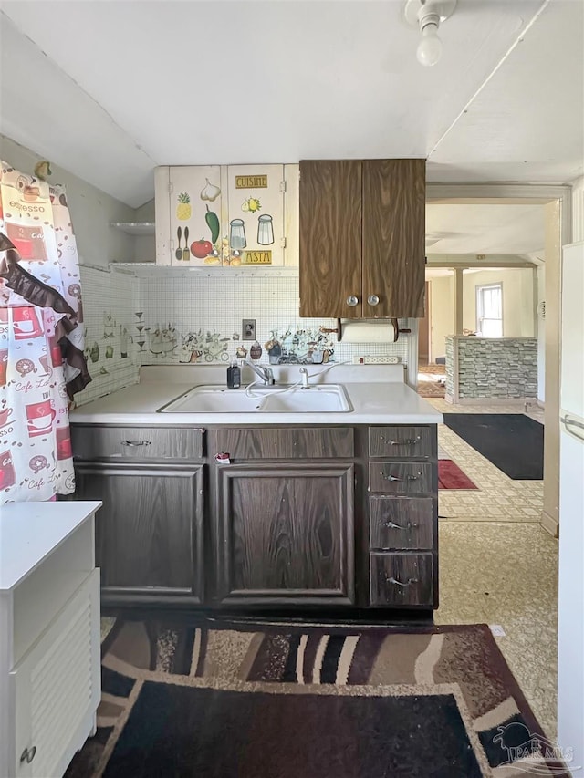 3020 Woodbury Cir, Cantonment, FL 32533 - kitchen featuring vaulted ceiling, light countertops, and dark brown cabinetry