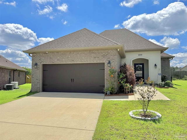405 Waterbury Ct, Cantonment, FL 32533 - french country style house with a garage, brick siding, concrete driveway, and a front yard