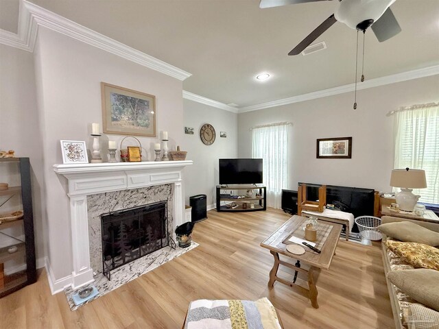 405 Waterbury Ct, Cantonment, FL 32533 - living room with light wood finished floors, ornamental molding, a high end fireplace, ceiling fan, and baseboards