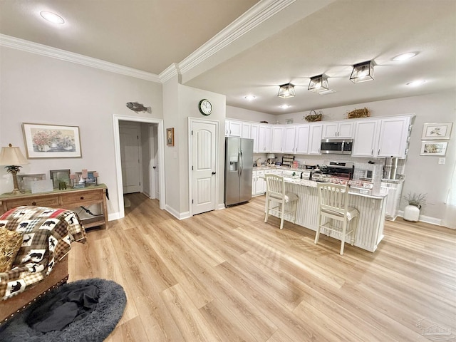 405 Waterbury Ct, Cantonment, FL 32533 - kitchen with appliances with stainless steel finishes, crown molding, a breakfast bar, white cabinets, and baseboards