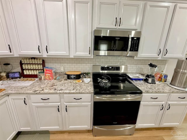 405 Waterbury Ct, Cantonment, FL 32533 - kitchen featuring appliances with stainless steel finishes, white cabinetry, and light stone countertops