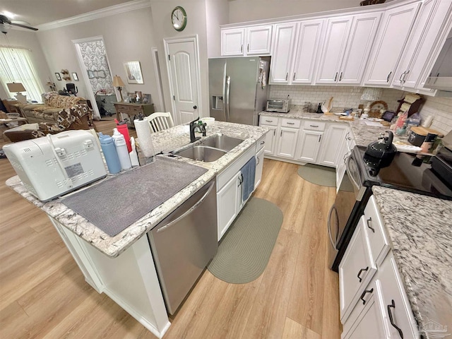 405 Waterbury Ct, Cantonment, FL 32533 - kitchen with stainless steel appliances, a sink, light wood-type flooring, white cabinets, and crown molding