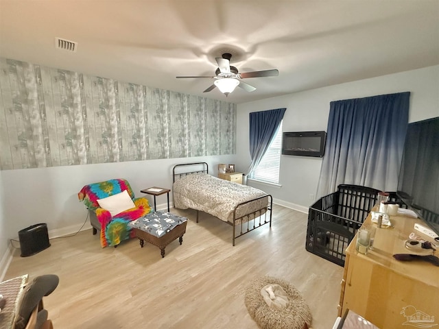 405 Waterbury Ct, Cantonment, FL 32533 - bedroom featuring wood finished floors, baseboards, a ceiling fan, and an accent wall