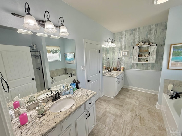 405 Waterbury Ct, Cantonment, FL 32533 - full bathroom featuring a bath, two vanities, a shower stall, and baseboards