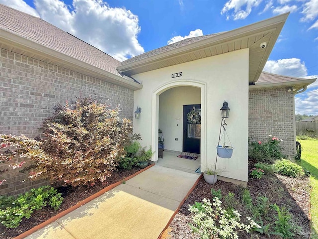 405 Waterbury Ct, Cantonment, FL 32533 - view of exterior entry with brick siding, roof with shingles, and a security system