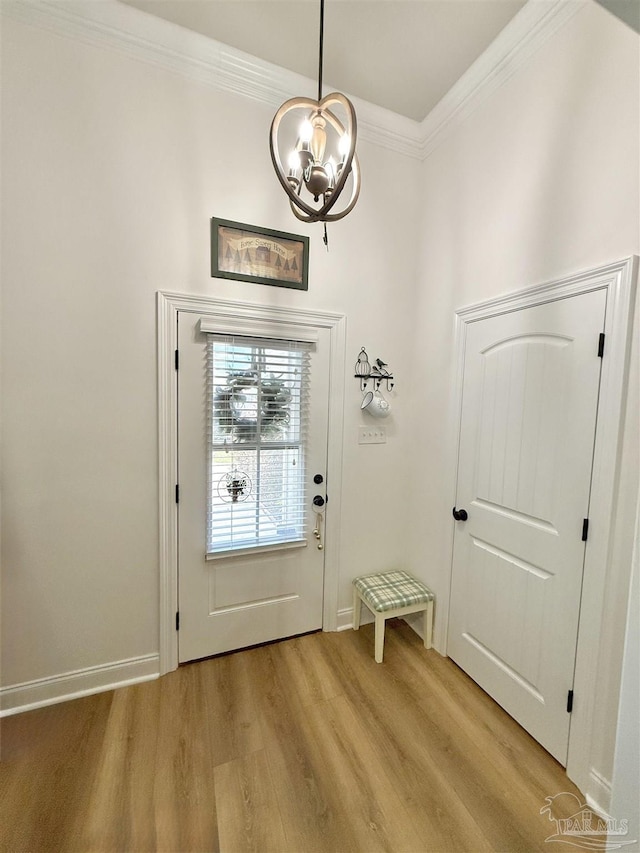 405 Waterbury Ct, Cantonment, FL 32533 - doorway with a chandelier, light wood finished floors, crown molding, and baseboards