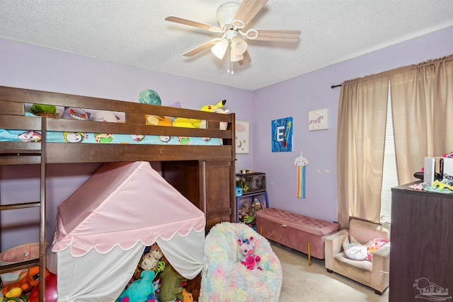 carpeted bedroom with a textured ceiling and ceiling fan