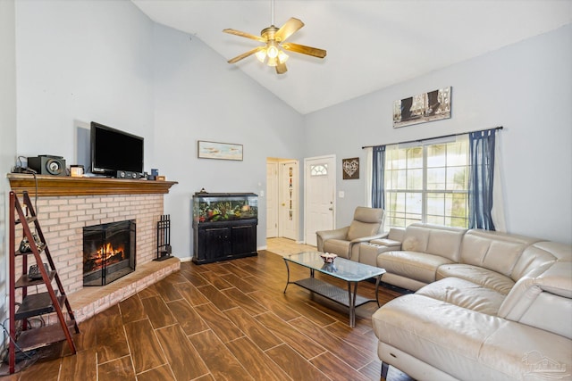 living room with wood-type flooring, a fireplace, ceiling fan, and high vaulted ceiling