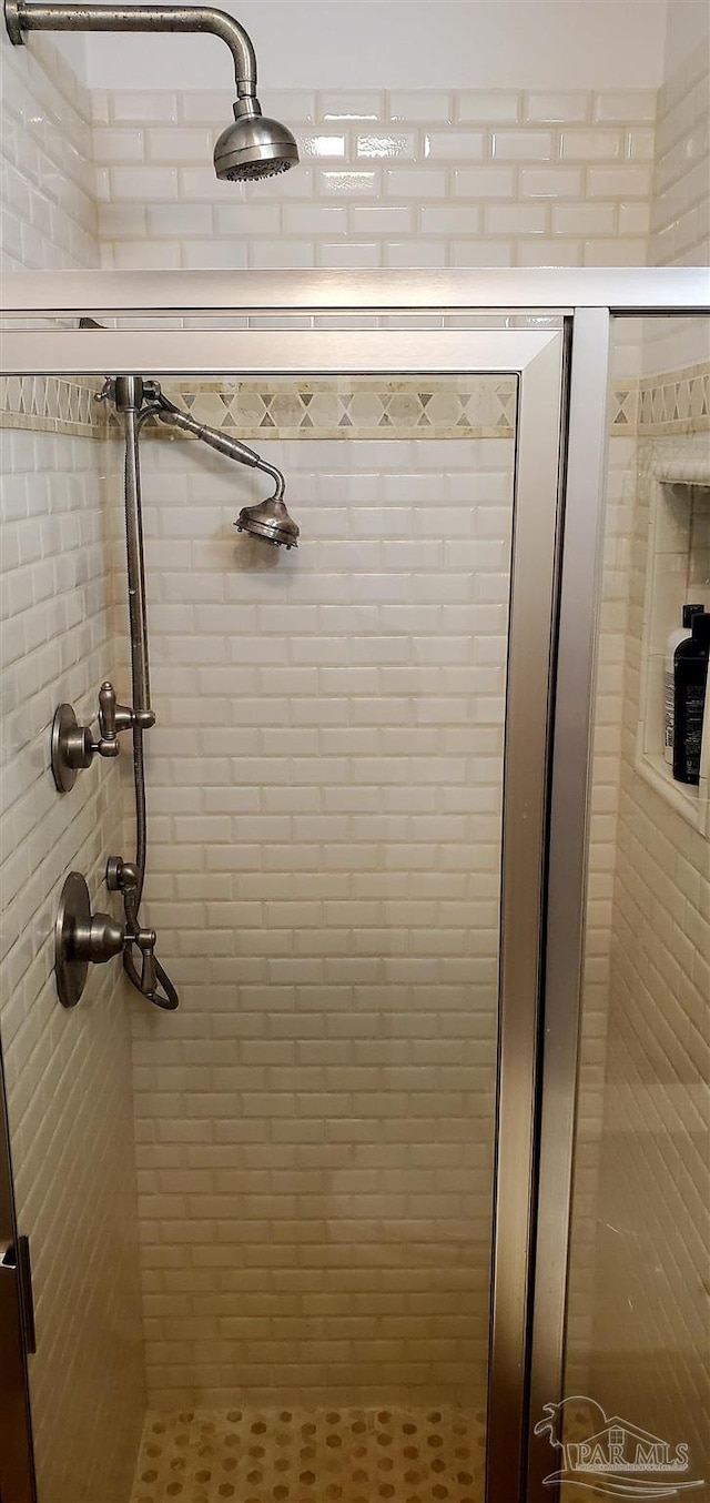 bathroom with a shower with door