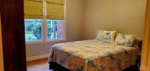 bedroom with hardwood / wood-style floors