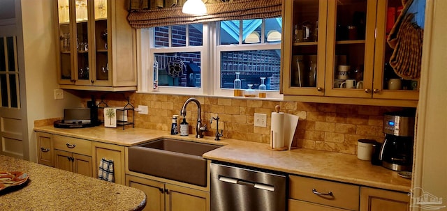 kitchen with decorative backsplash, sink, and stainless steel dishwasher