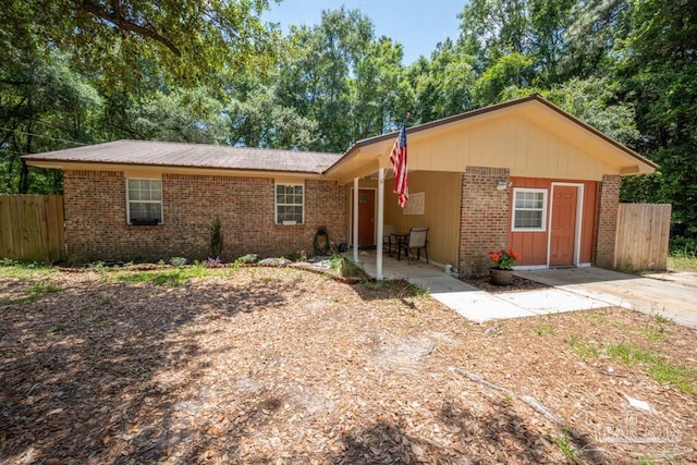 8687 John Hamm Rd, Milton, FL 32583 - ranch-style house with brick siding and a patio