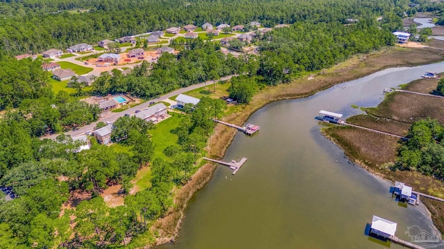 birds eye view of property with a forest view and a water view