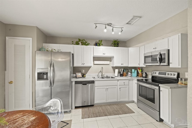 kitchen with visible vents, a sink, light countertops, appliances with stainless steel finishes, and white cabinetry