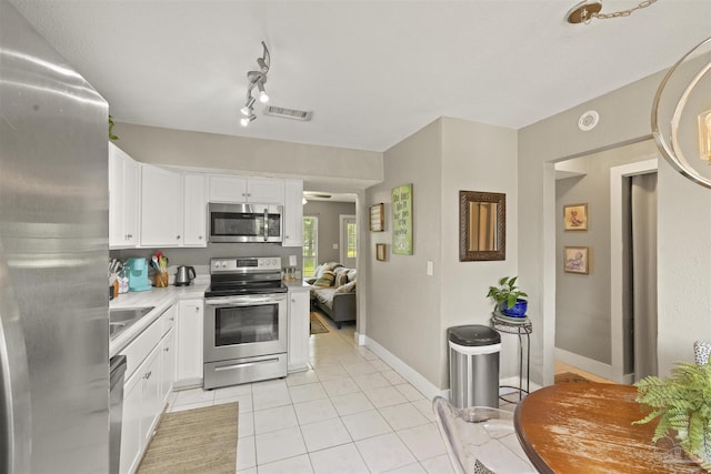 kitchen featuring visible vents, white cabinetry, appliances with stainless steel finishes, light countertops, and light tile patterned floors