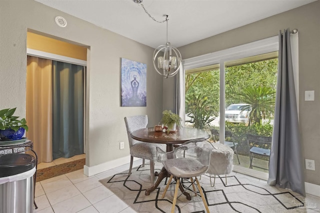 dining room featuring a chandelier and light tile patterned flooring