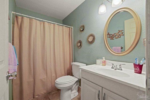 full bathroom featuring tile patterned floors, a shower with shower curtain, toilet, and vanity