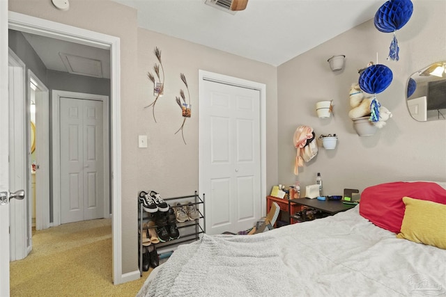 bedroom featuring attic access, light colored carpet, visible vents, and baseboards