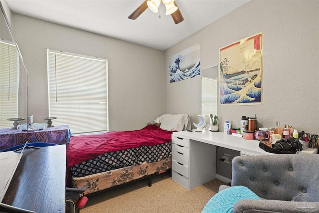 bedroom featuring light colored carpet and ceiling fan