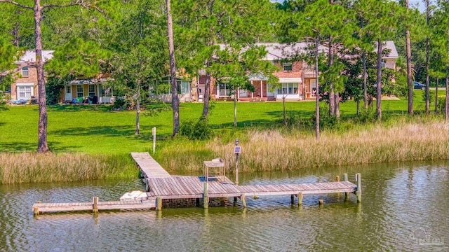 dock area featuring a water view and a lawn