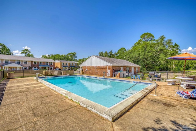 pool featuring a patio and fence