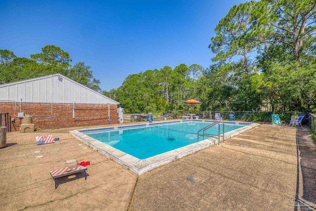 pool featuring a patio and fence