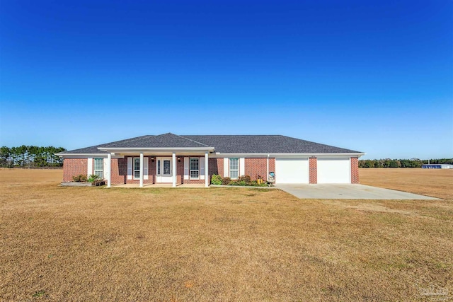 view of front of home with a front yard, a porch, and a garage