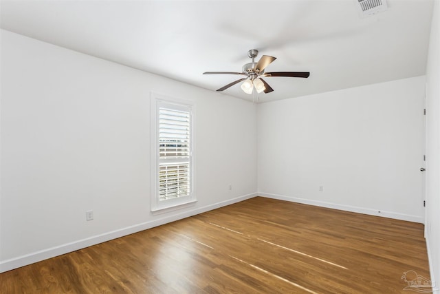 spare room featuring hardwood / wood-style floors and ceiling fan