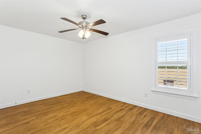 spare room with wood-type flooring and ceiling fan