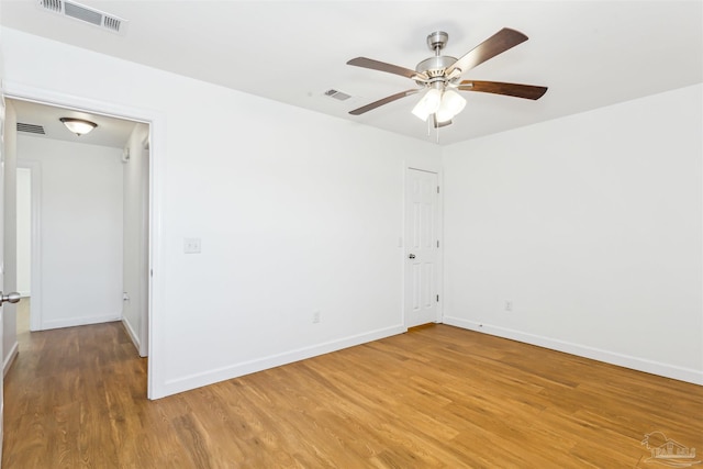 spare room featuring hardwood / wood-style floors and ceiling fan