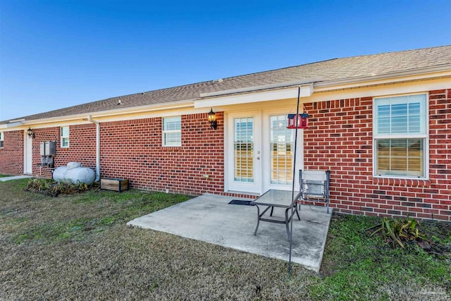 rear view of property with a yard and a patio