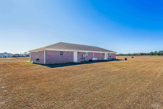 rear view of house featuring a yard