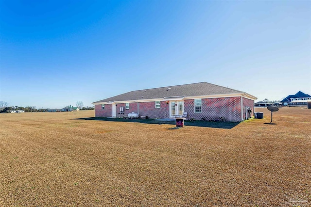 back of property featuring a yard