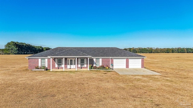 ranch-style house with a porch, a garage, and a front lawn