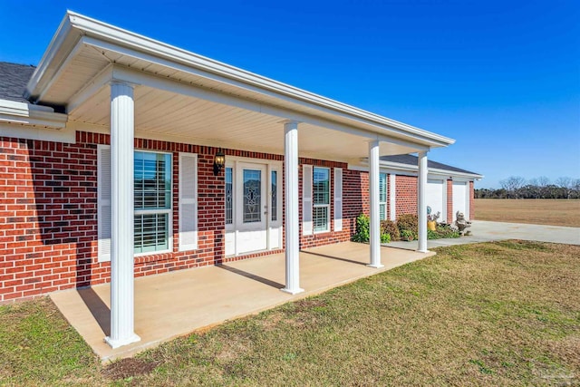 rear view of property with a porch and a yard