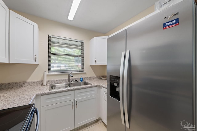 702 Beauvais Rd, Pensacola, FL 32505 - kitchen featuring a sink, light countertops, white cabinets, and stainless steel fridge