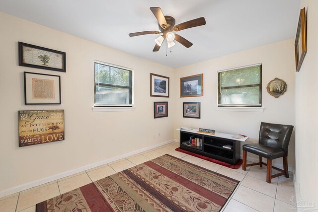 702 Beauvais Rd, Pensacola, FL 32505 - sitting room featuring baseboards, a ceiling fan, and light tile patterned flooring